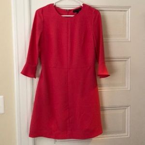 Pink, three-quarter bell sleeve dress.